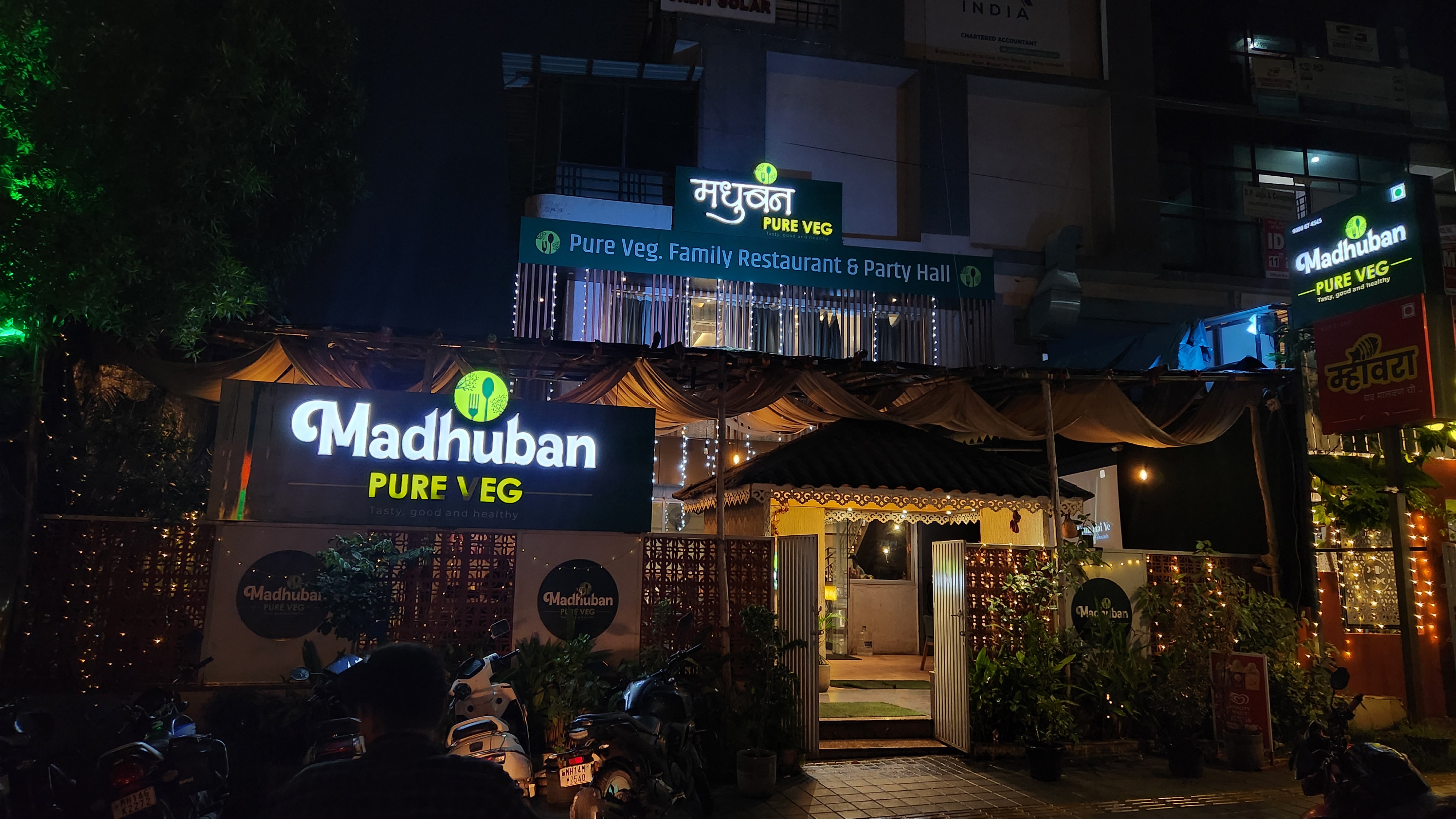 Madhuban Pure Veg family restaurant lit up on a Nashik evening